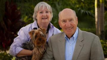 A posed photo of Julie and Paul Ben-Susan with their dog