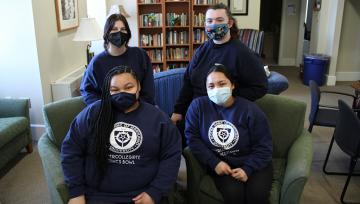 Notre Dame's four Ethics Bowl participants pictured in a study area on campus.