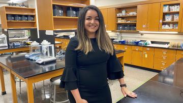 A posed shot of Paola Rivera Mudafort inside a lab classroom at NDMU