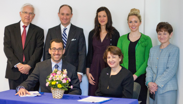 Group photo of administrators signing agreement