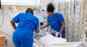 Nursing students working on a patient