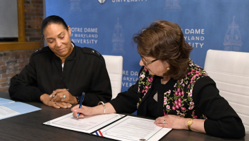 Dr. Yam & Maj. Gen. Linda L. Singh sign partnership