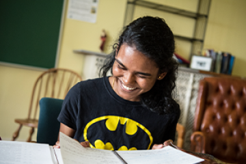 student looking down at her notebook