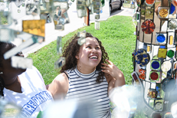 Student looking at glass artwork at the Visionary Arts Museum