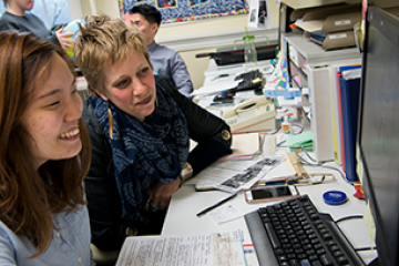 ELI students looking at a computer