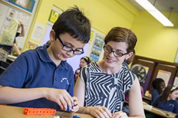 Teacher helping student 