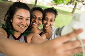 Three students taking a selfie outside