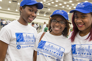 Three student volunteers at a service event