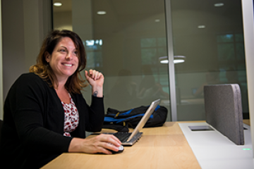 Woman sitting at a desk with a laptop