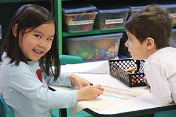 Little girl and boy coloring a picture