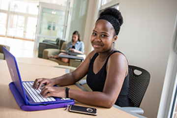 Student filling out a form on a laptop