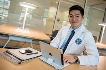 Pharmacy student working on a laptop