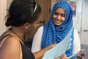 Two students looking over a list