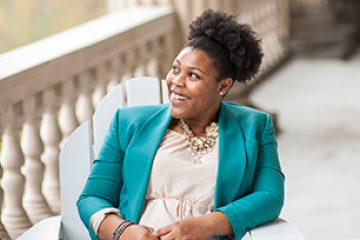 a women in green jacket smiling