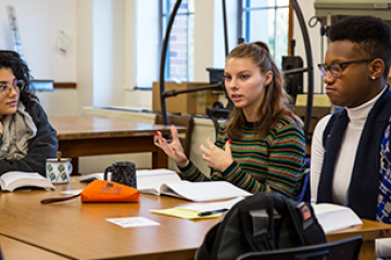 3 art therapy students having a discussion in class