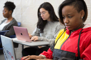 Students writing on laptops