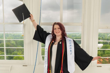 Rebecca Becraft posing in cap and gown