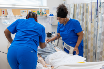 Nursing students working on a patient