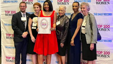 5 people pose with award winner