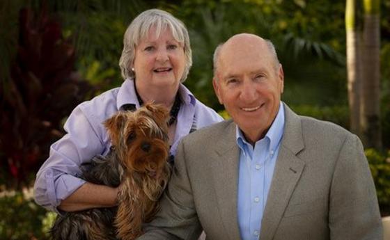 A posed photo of Julie and Paul Ben-Susa with their dog