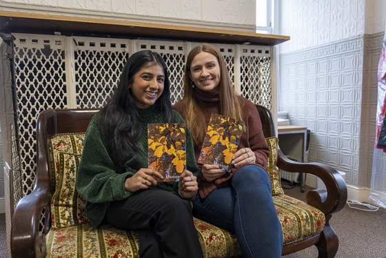 Two students holding Damozel