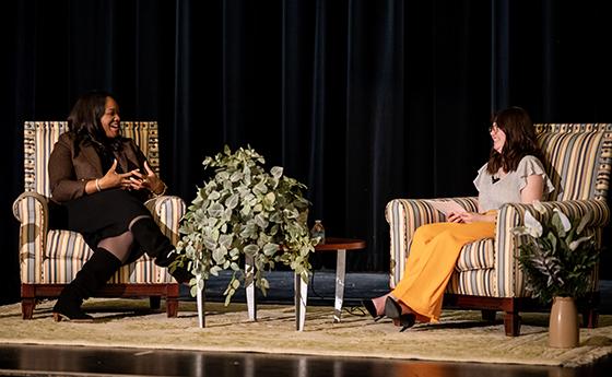 Allison Lawrence and Jensen Armstrong sitting in chairs on stage 