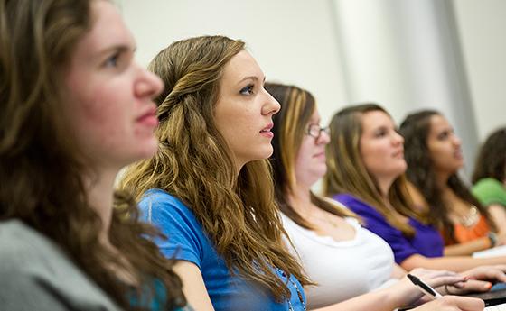 Five women sit in a classroom