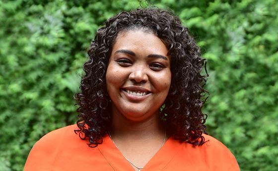 headshot of ashley hodges in orange shirt