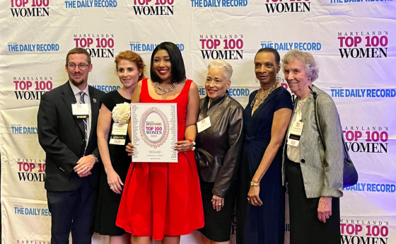 5 people pose with award winner