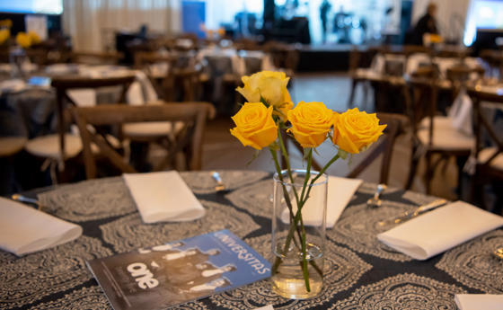 Yellow flowers and table set up for a fancy dinner