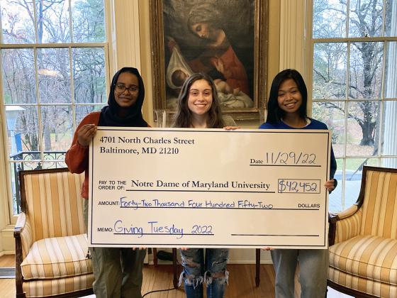 Students holding giant check