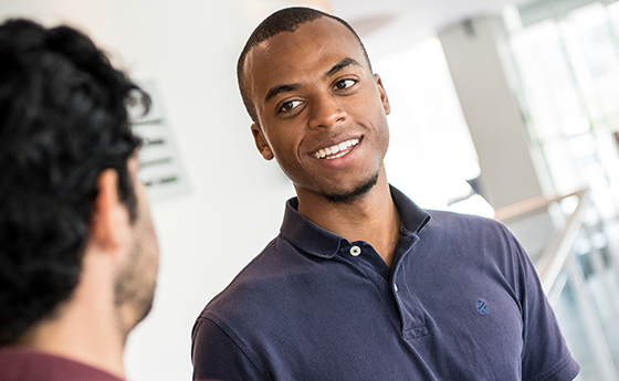 Two male students having a conversation