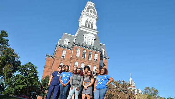 Students stand in front of Gibbons Hall