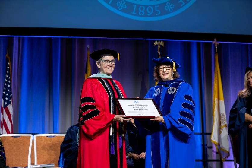 Nancy Gilchriest, SSND presents honorary degree to President Marylou Yam