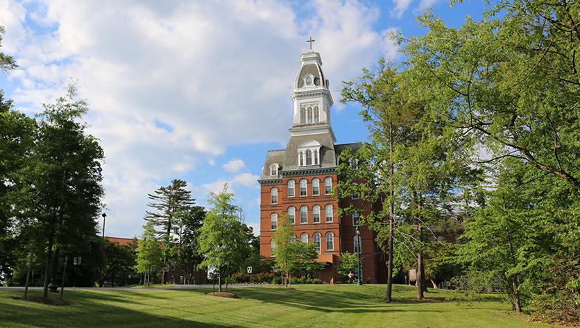 Caroline Hall pictured from the road leading up to campus.