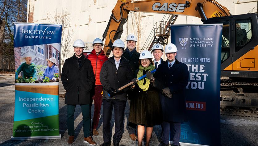 Group shot of NDMU and Brightview officials at demolition site