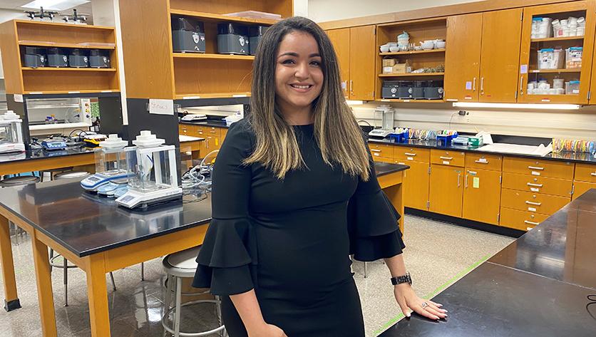 A posed shot of Paola Rivera Mudafort inside a lab classroom at NDMU