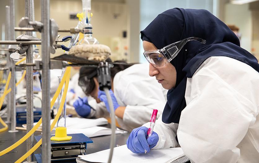 An NDMU student works in a lab on campus