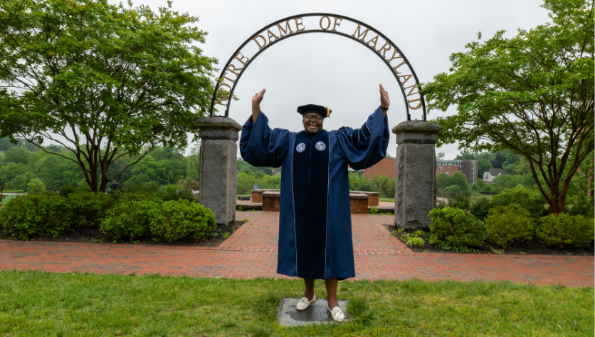 Lavorette Preston posing in front of NDMU archway