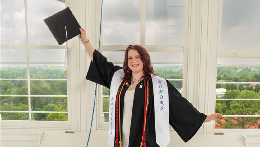 Rebecca Becraft posing in cap and gown