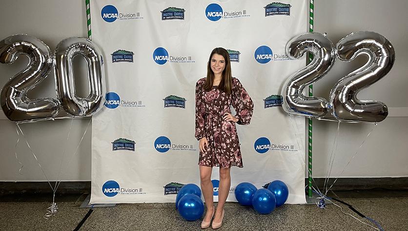 A posed shot of Taylor Bynion in front of the NDMU athletics backdrop