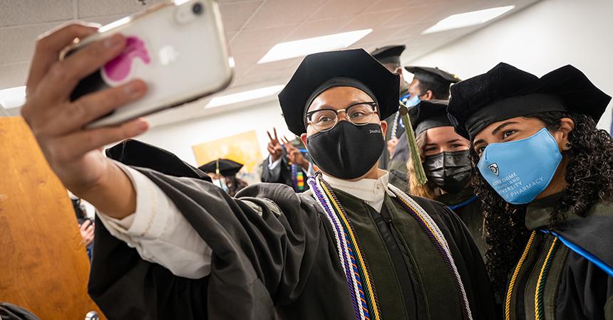 Pharmacy students take a selfie at their graduation