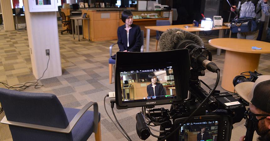 Dr. Lin is interviewed in a science classroom