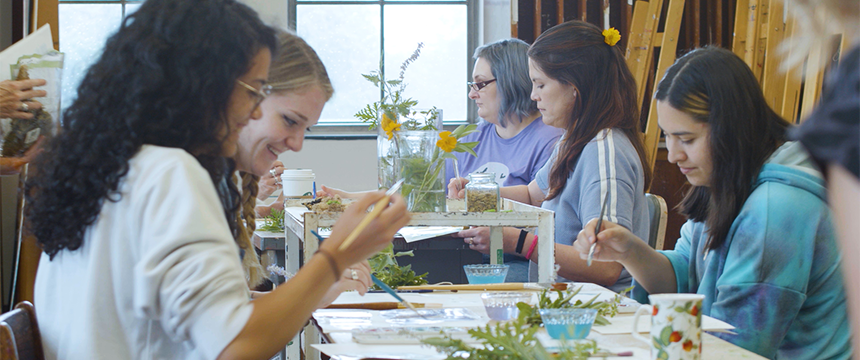 Table of art therapy students working on art projects