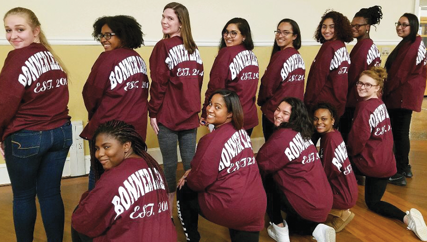 Group photo of bonner leaders looking over their shoulder wearing bonner shirts