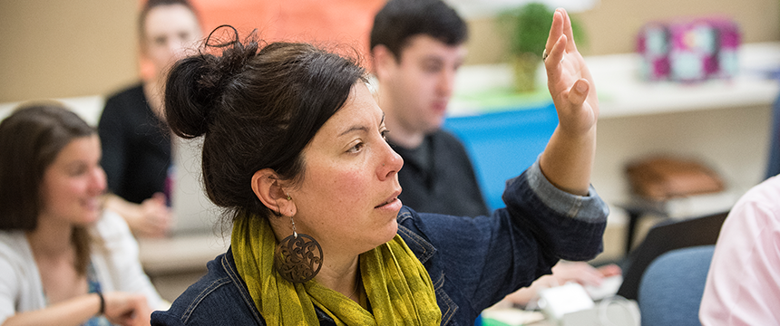 Woman raising her hand in class