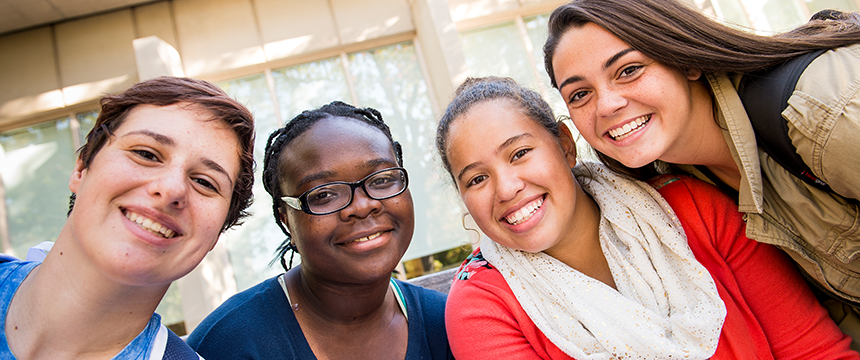 Close up of four smiling female students