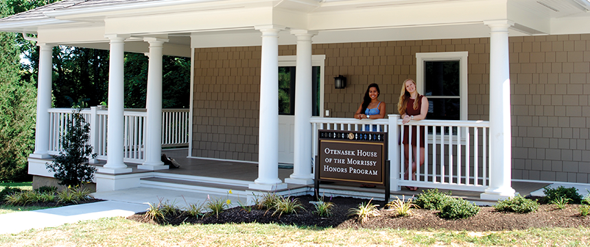 Two women standing on the porch of the Otenasek House