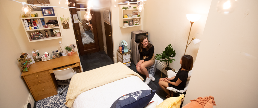 two girls chatting in the dorm