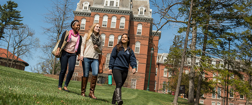 Three female students walking on campus